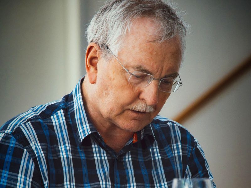 An older man reading at a table